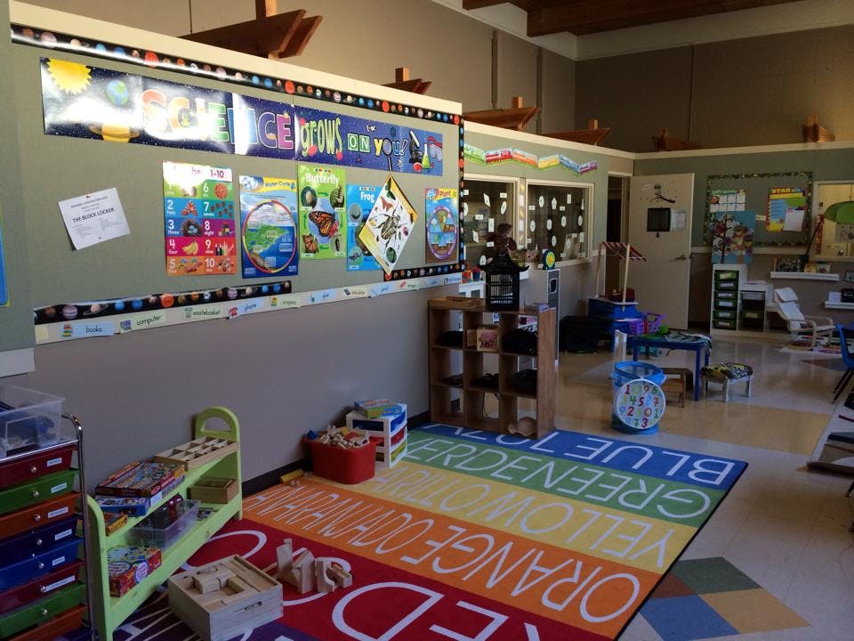Classroom with colorful rug and bulletin board displays