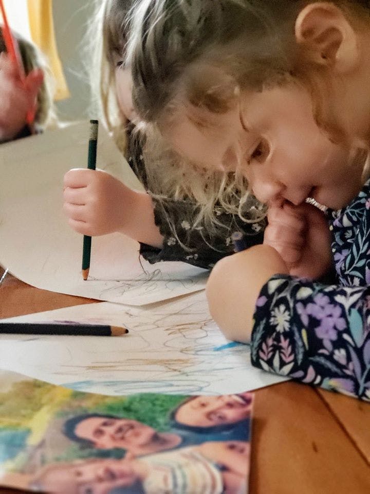 Child drawing on paper with a pencil