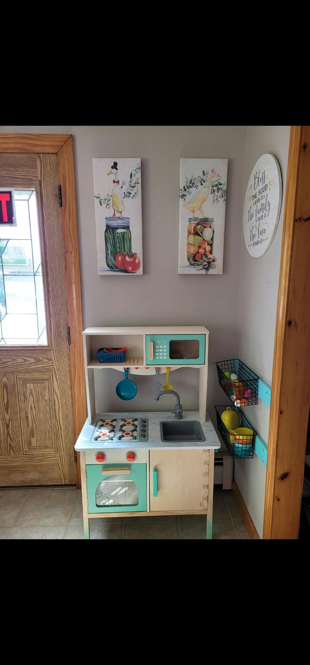 Child's play kitchen with stove, sink, and microwave
