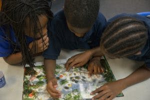 Three children looking at a book