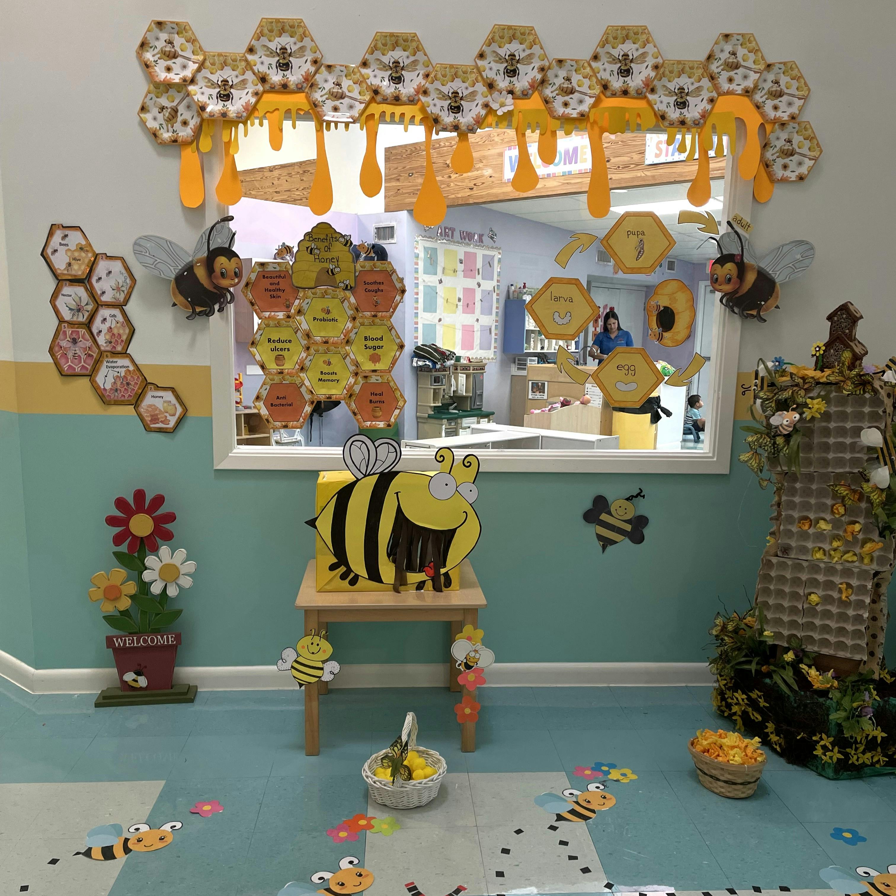 Classroom decorated with bee-themed cutouts, honeycomb, and honey-drip decorations
