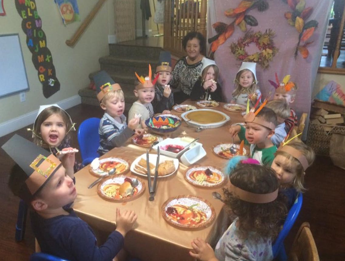 Children and adults at a table with food