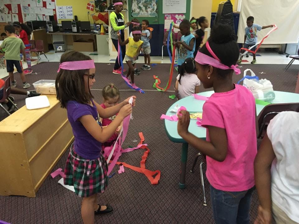 Children playing with colorful ribbons in a room