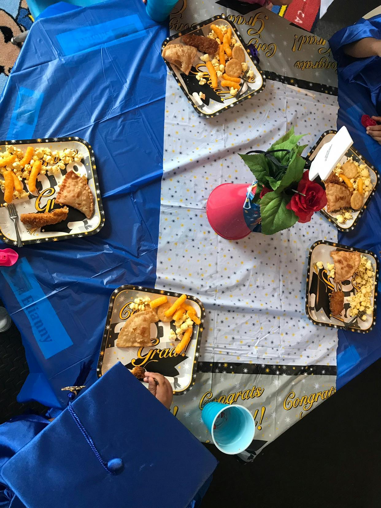 Plates of food on a table with a blue and white tablecloth