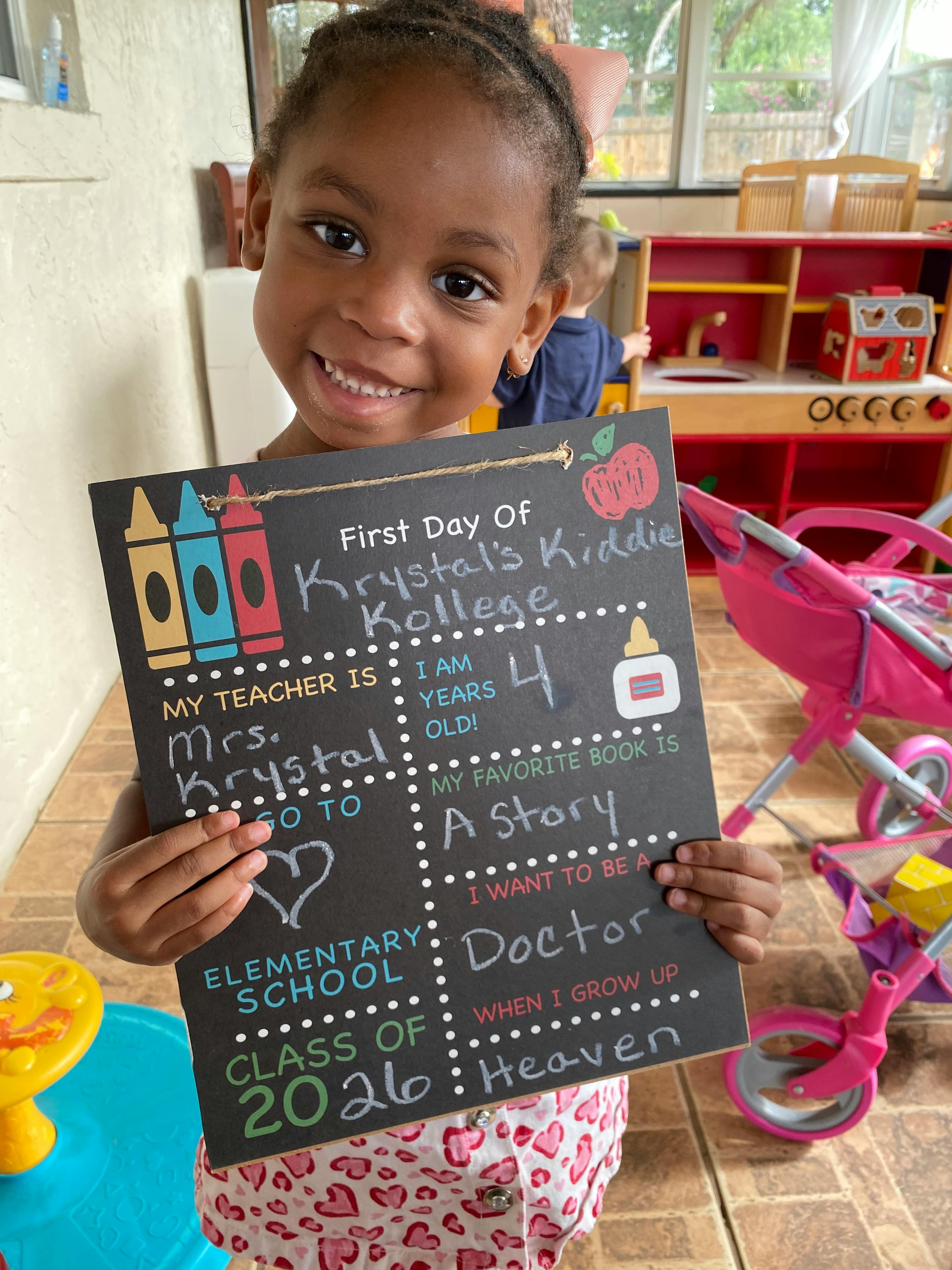 Child holding a first day of school sign