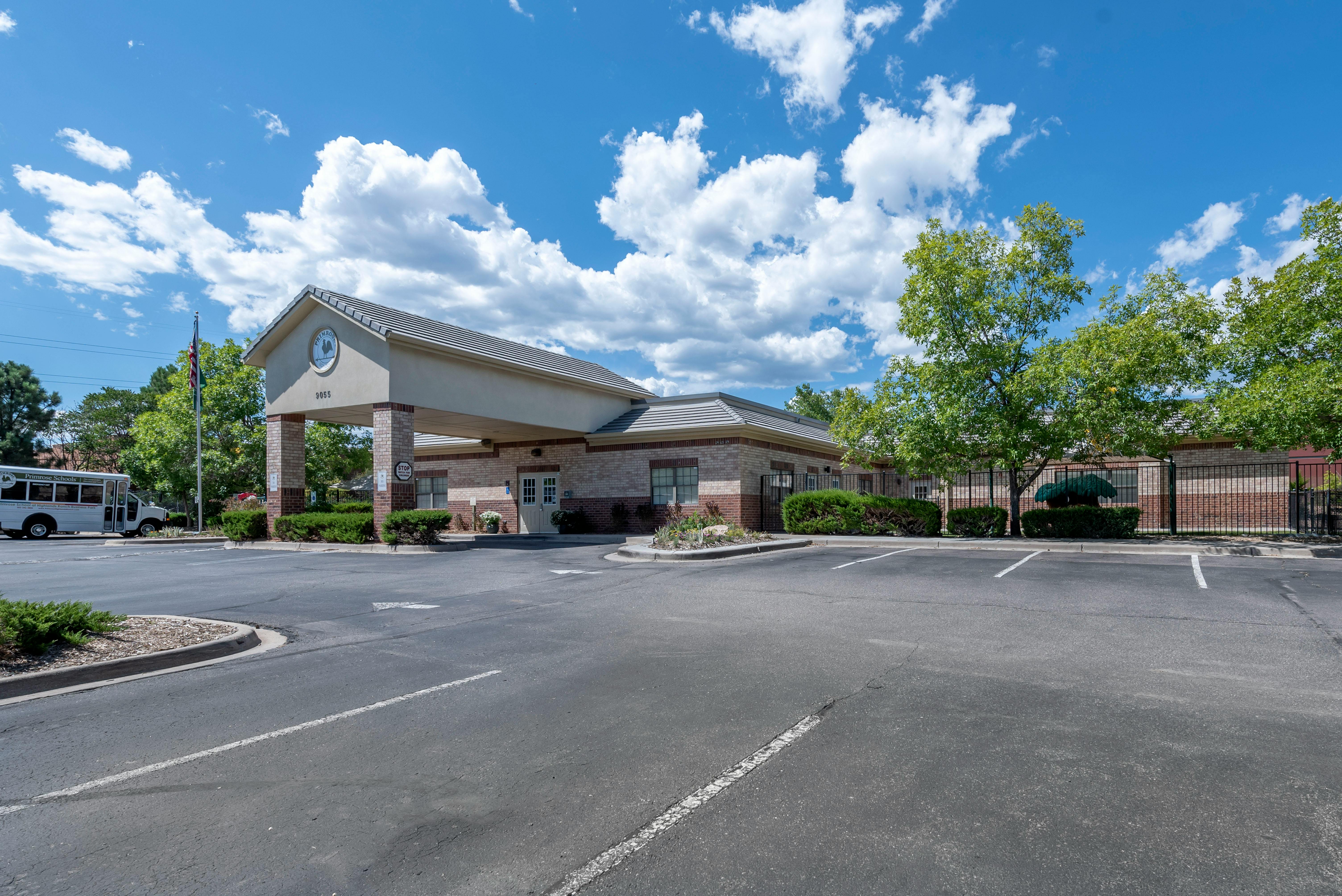 Exterior of a building with a drive-through entrance and a parking lot