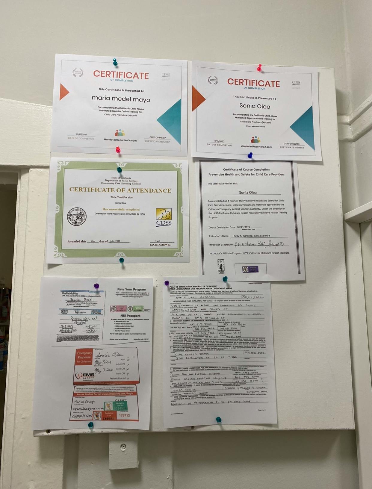 Certificates and documents pinned to a white board