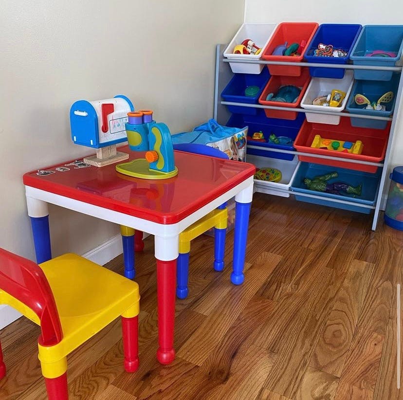 Child's table and chair with toy mailbox and microscope, toy storage unit