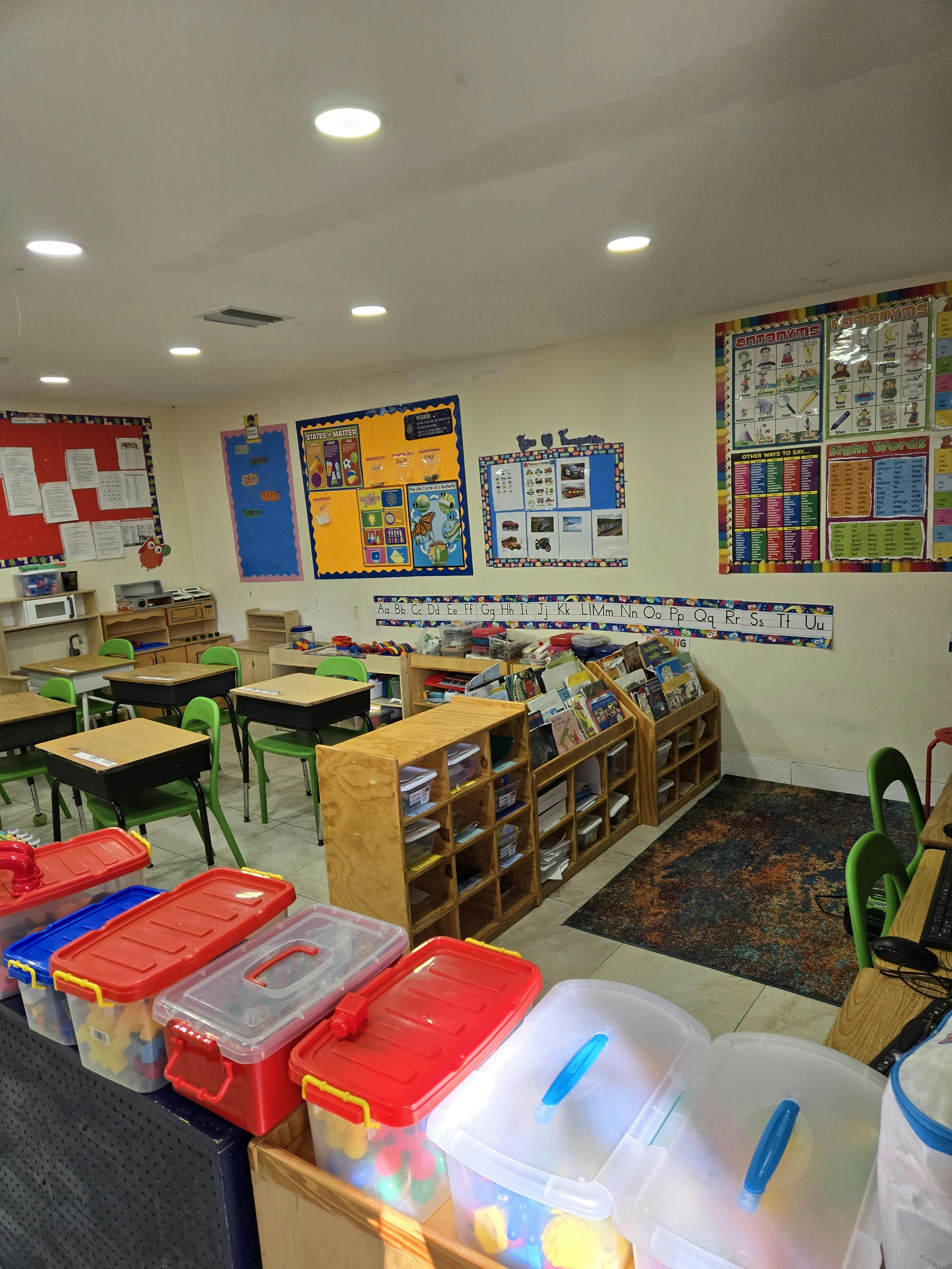 Classroom with desks, chairs, bookshelves, and colorful wall decorations