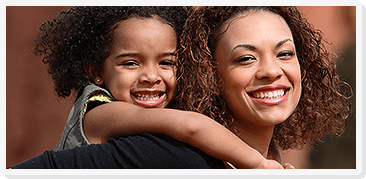 Person giving a child a piggyback ride