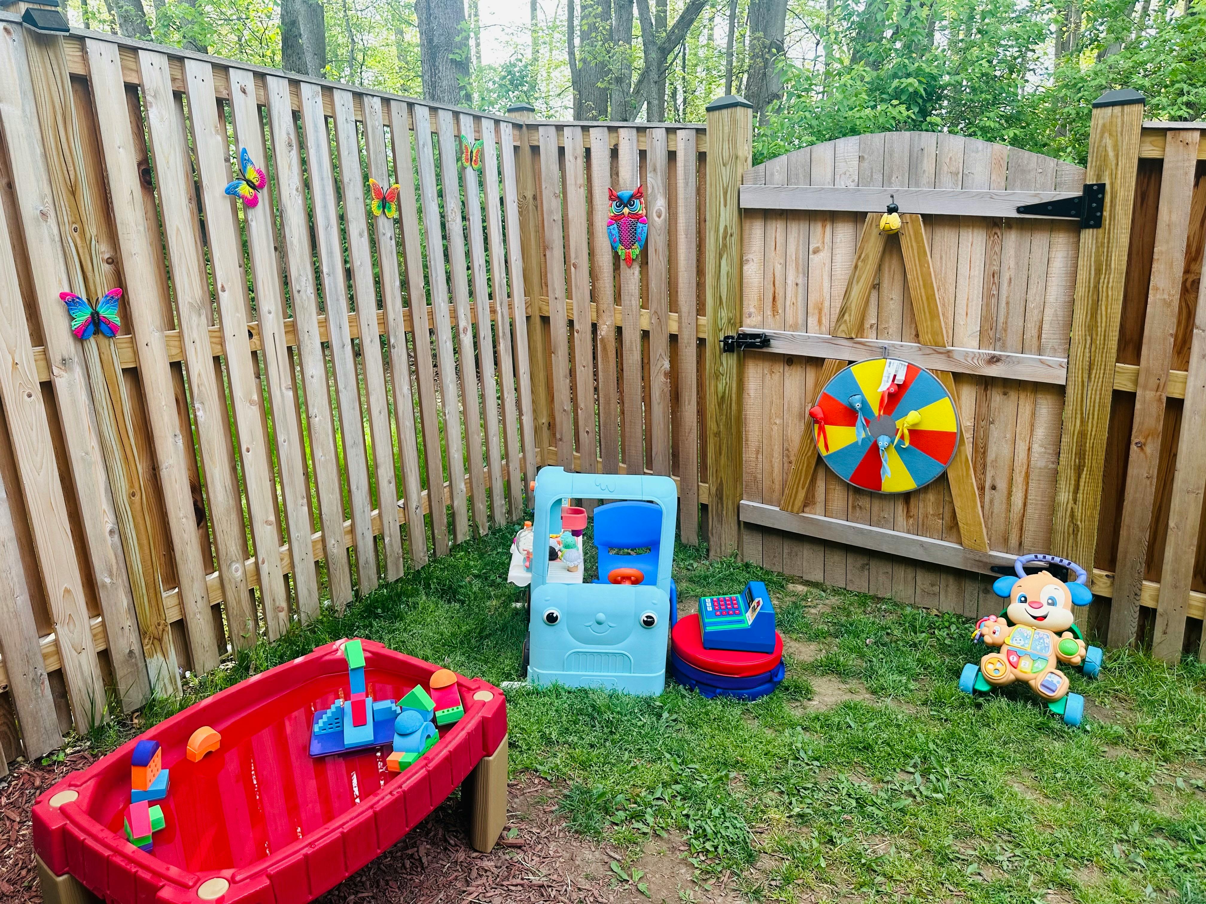 Children's play area with a red water table, blue toy car, and toy dog