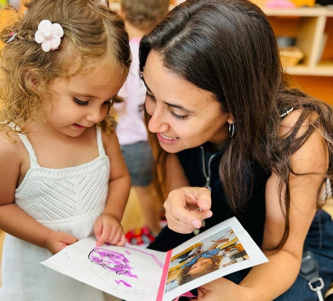 Adult and child looking at a book together