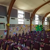 Empty room with rows of chairs facing a decorated wall