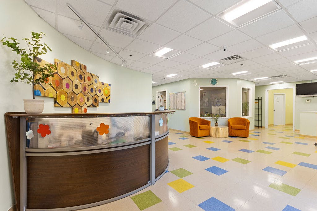 Reception desk in a waiting room with colorful floor tiles