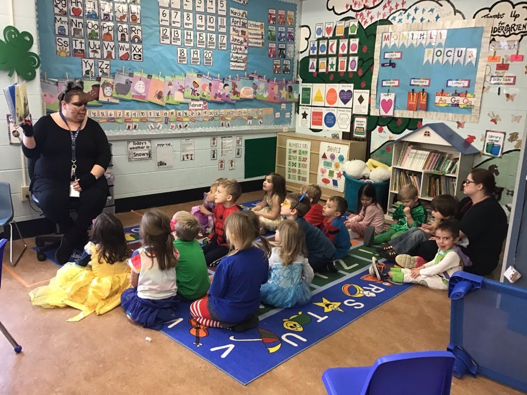 Person reading to children in a classroom