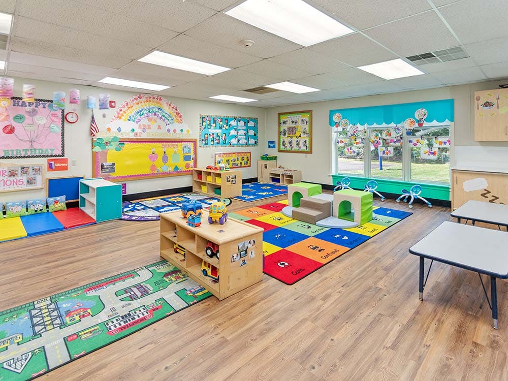 Colorful playroom or classroom with toys, rugs, and decorations