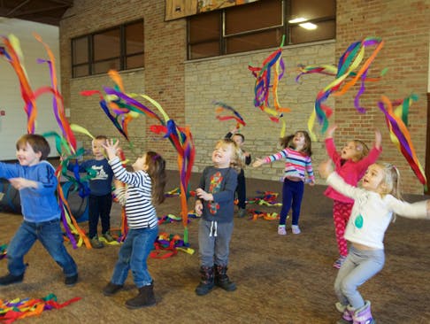 Children playing with colorful ribbons