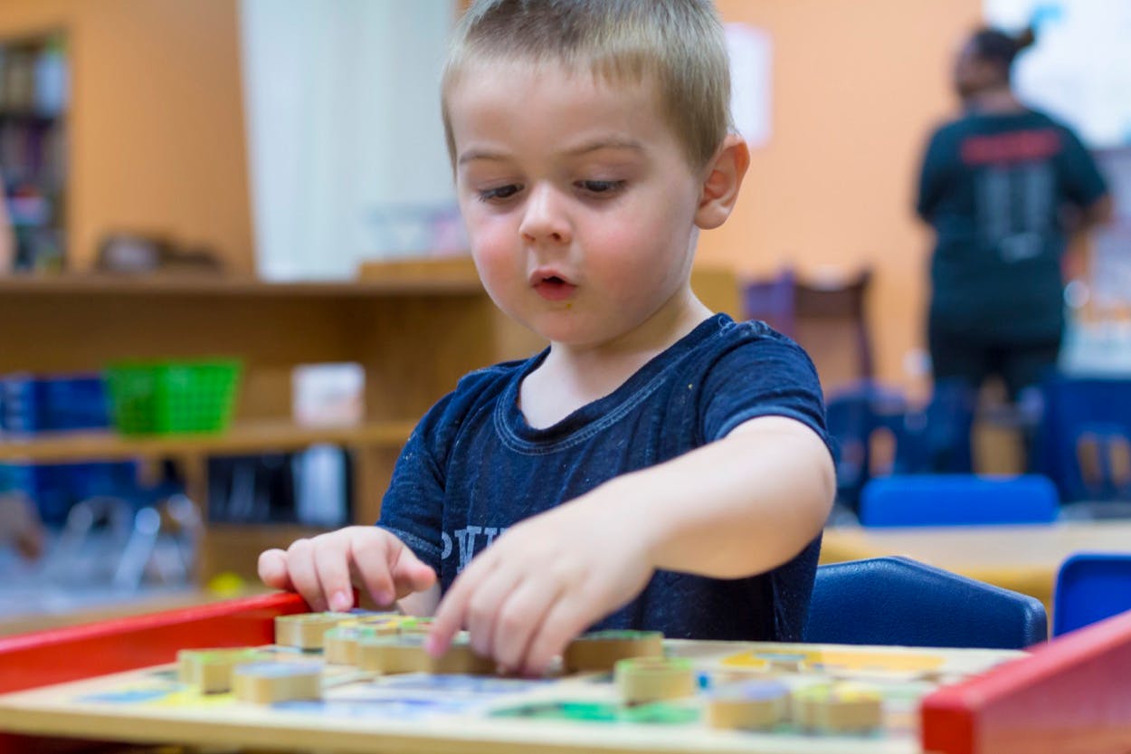 Child playing with blocks at a table