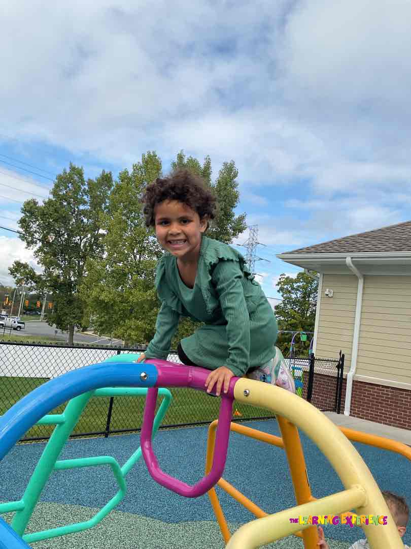 Child on a colorful playground climbing structure