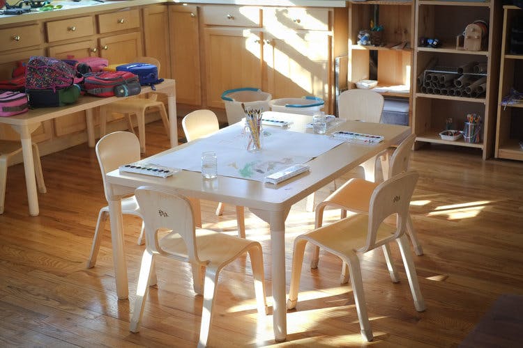 Classroom with small wooden tables and chairs