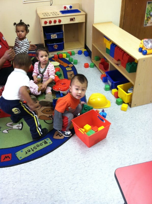 Children playing with blocks and toys in a classroom