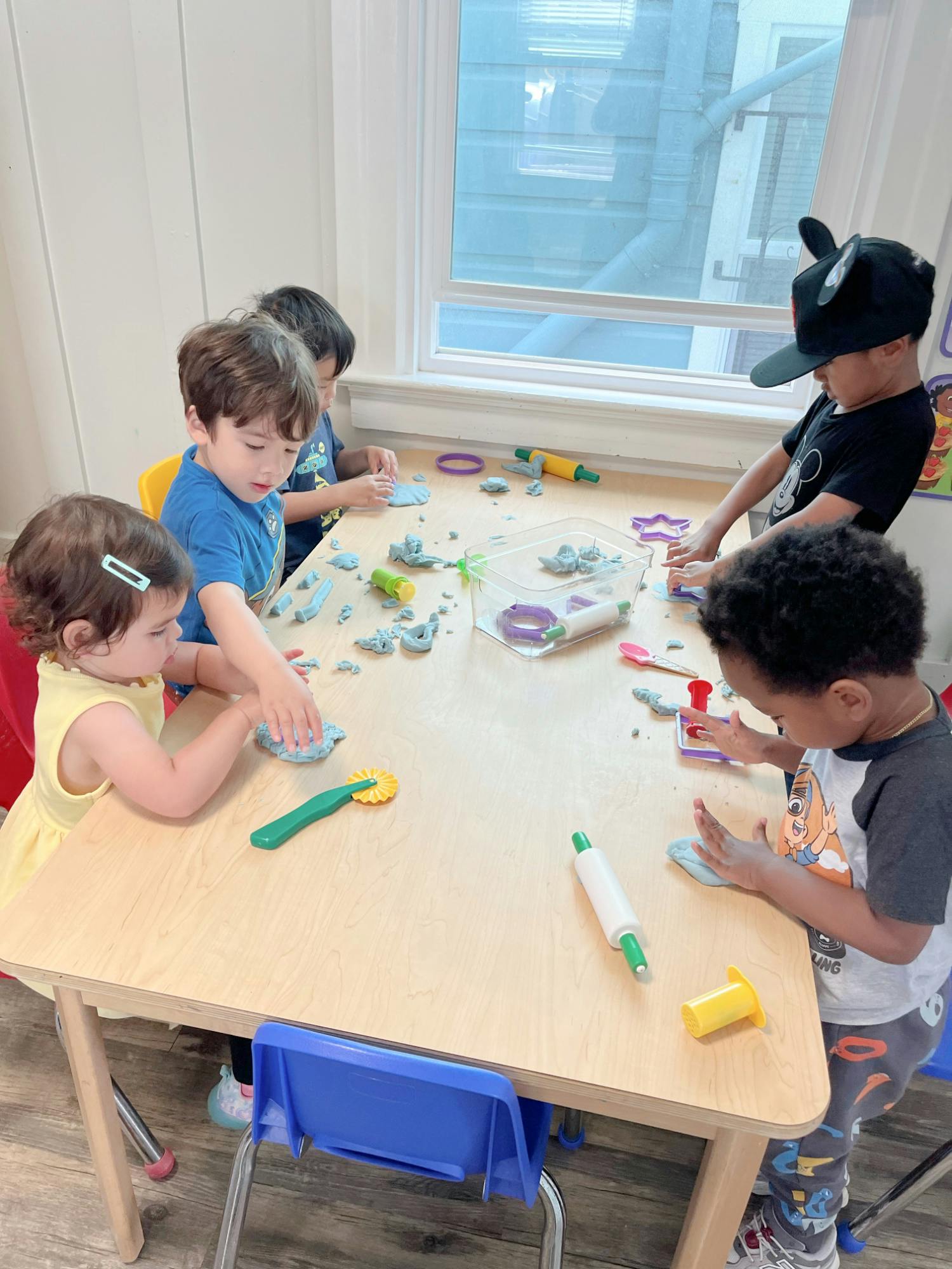 Children playing with modeling clay at a table