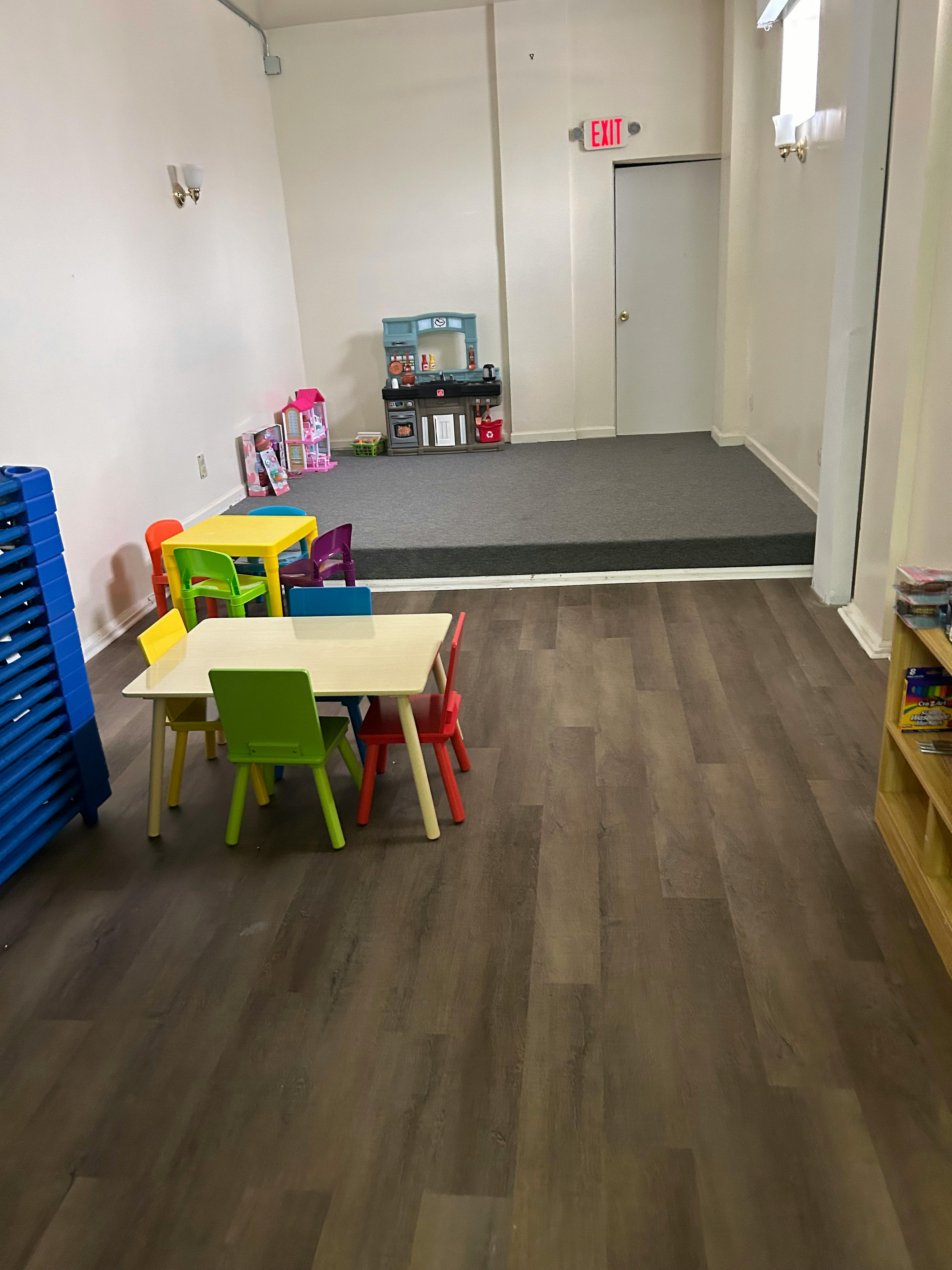 Children's tables and chairs in a room with a raised carpeted area