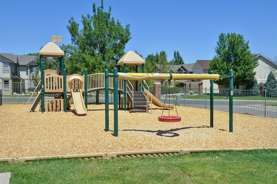 Playground with slides and swings on wood chips