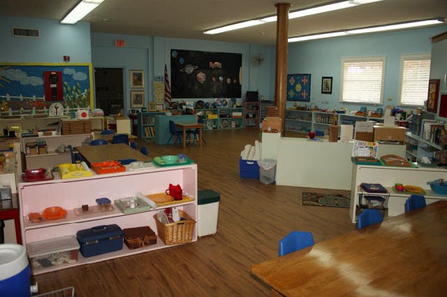 Classroom with shelves, tables, and chairs