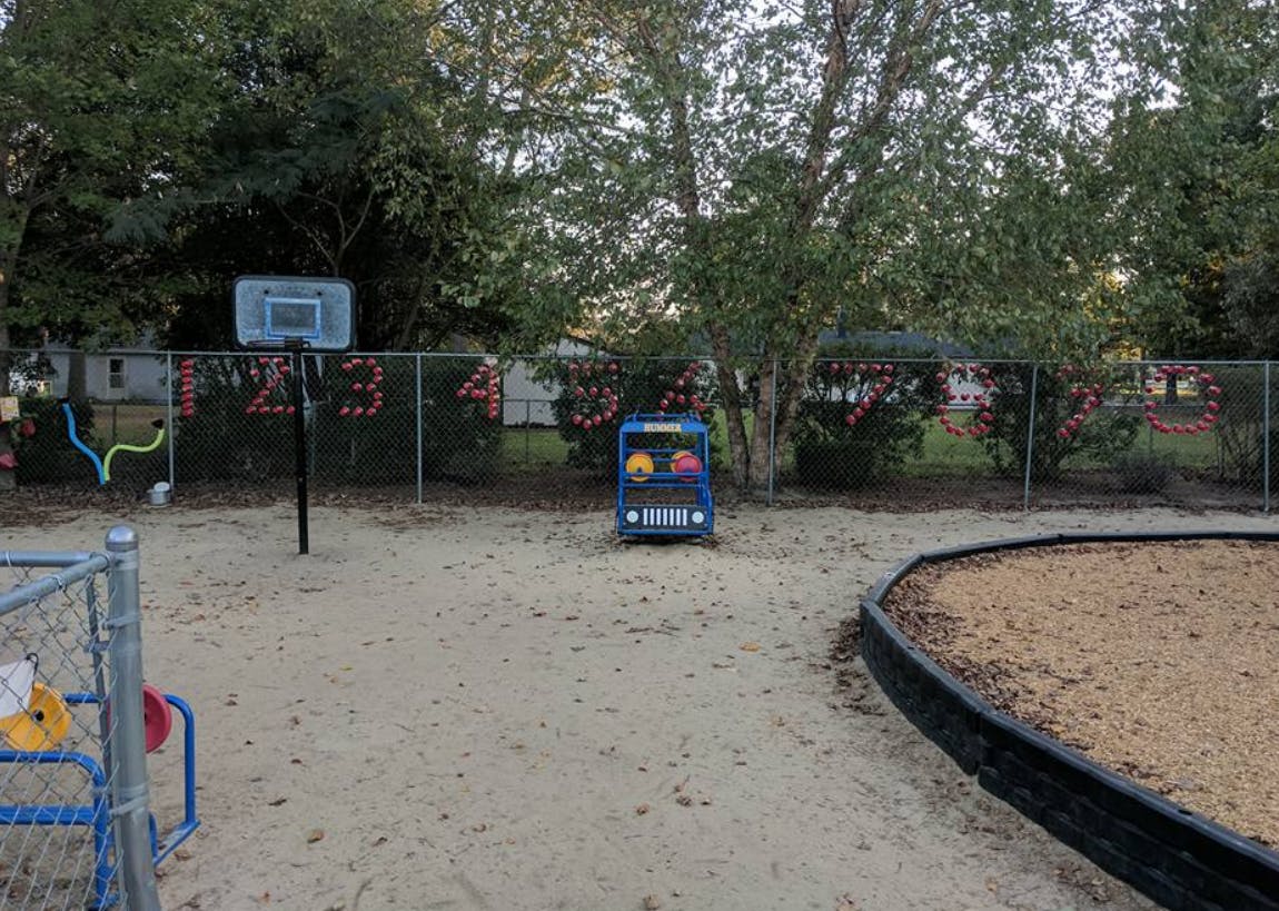 Playground with a basketball hoop and a blue toy car