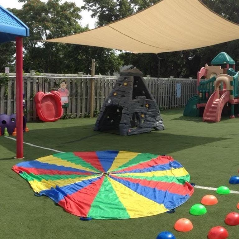 Playground with a colorful parachute on artificial turf