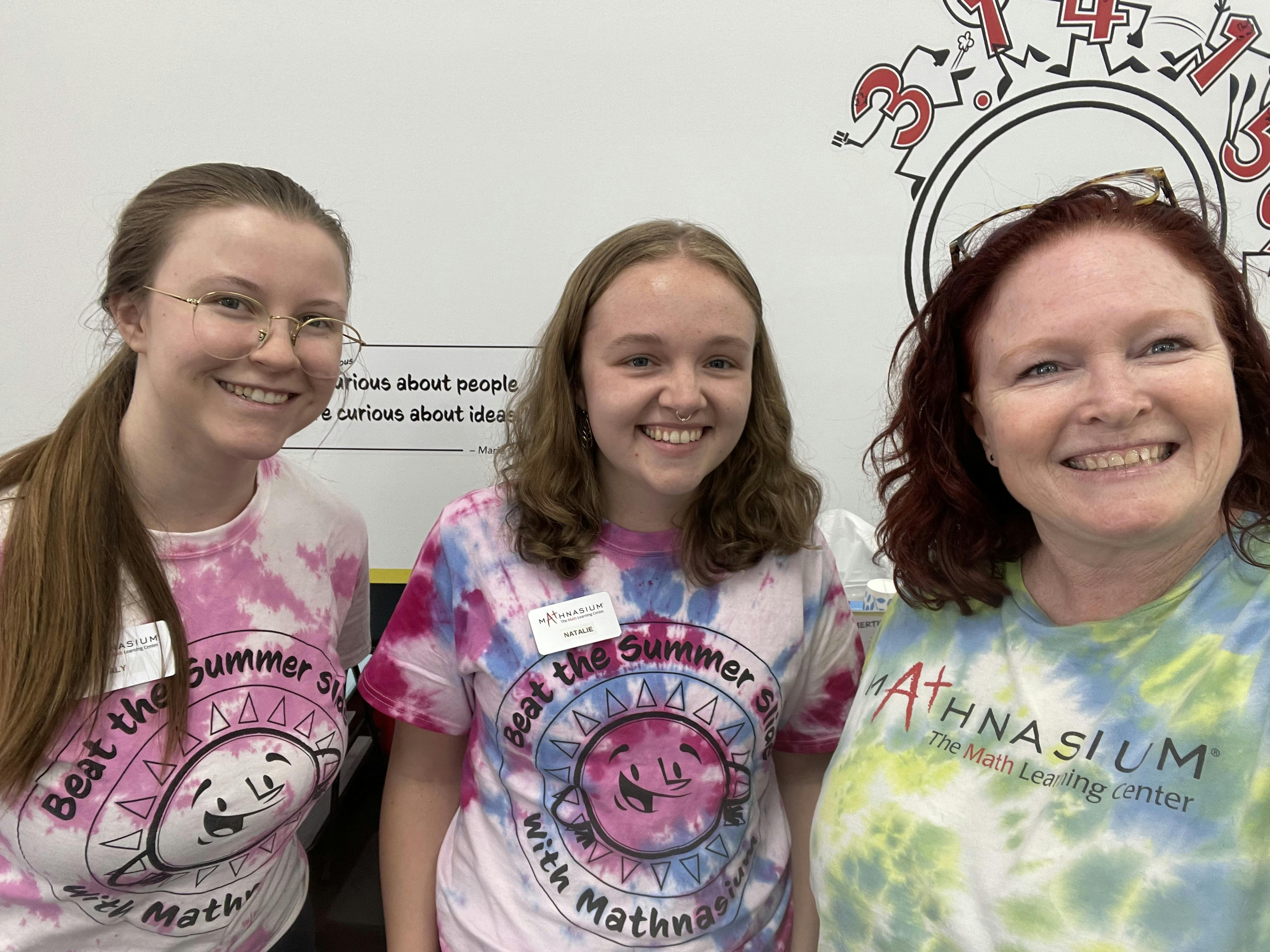 Three people smiling at the camera