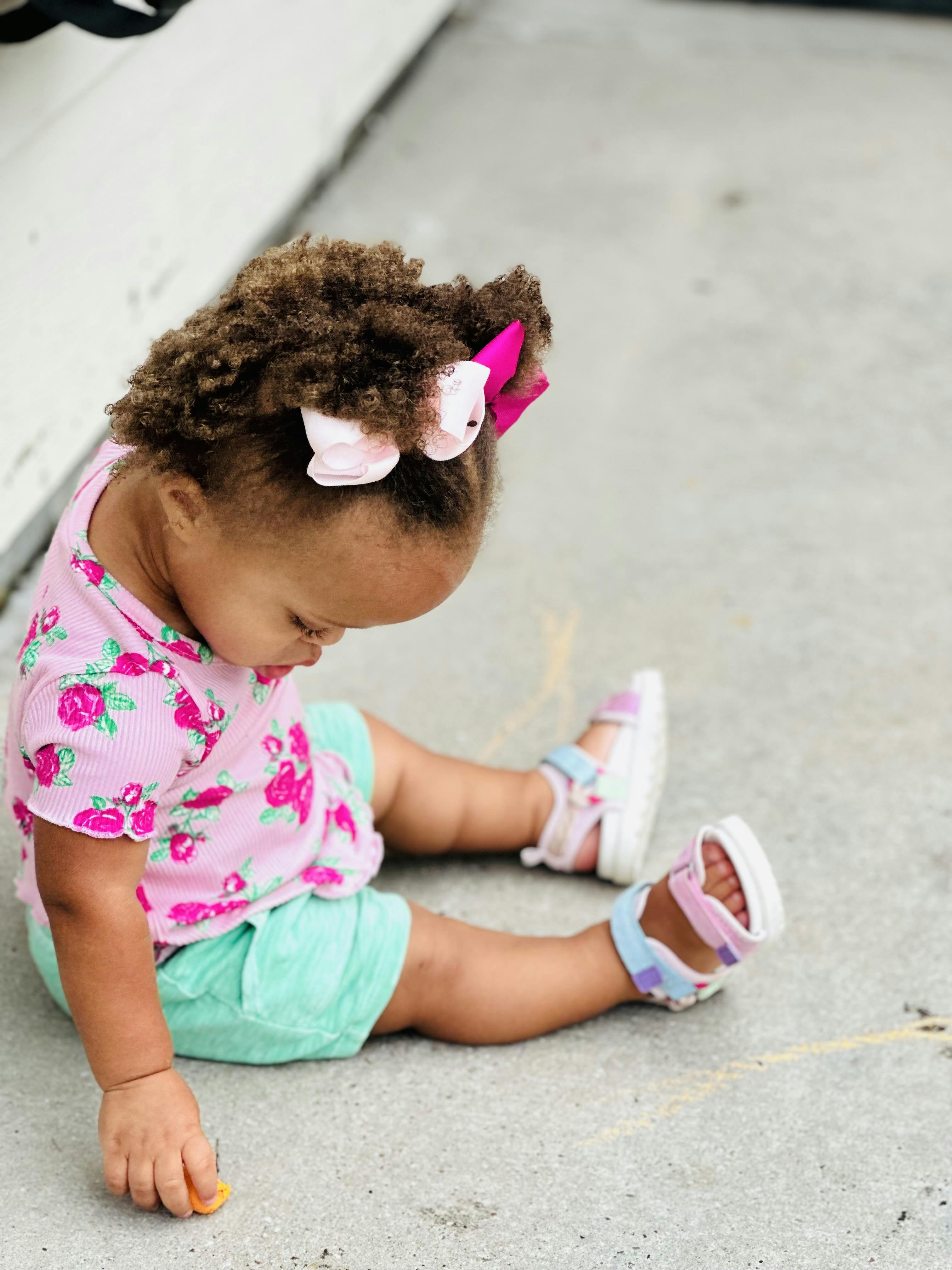 Child sitting on concrete ground
