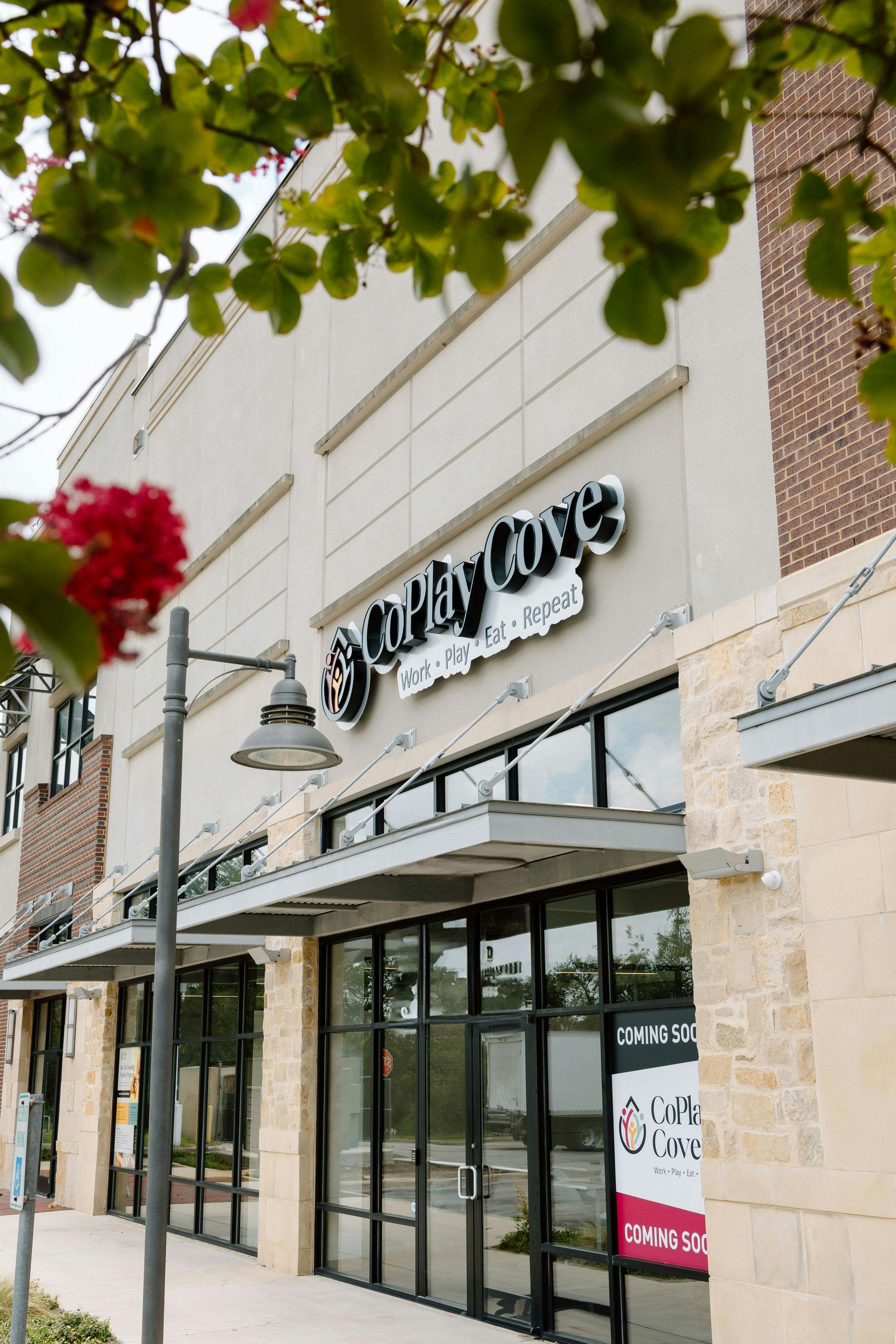 Storefront for CoPlay Cove with coming soon signage