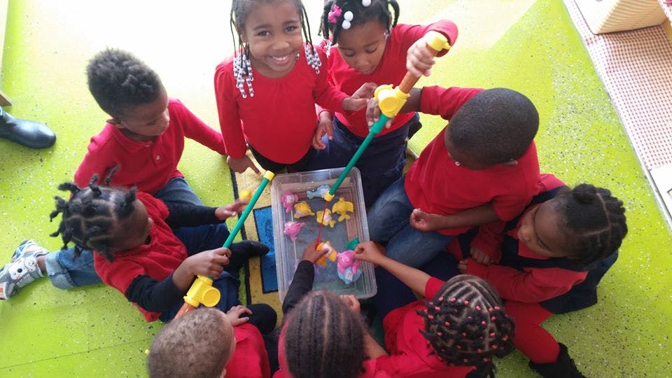 Group of children playing with fishing toys