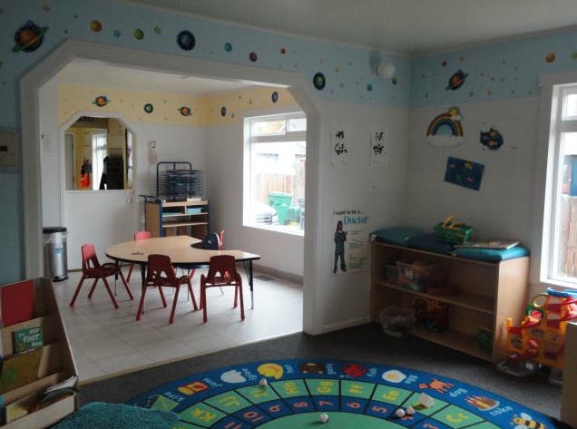 Playroom with a small table and chairs, and a colorful rug