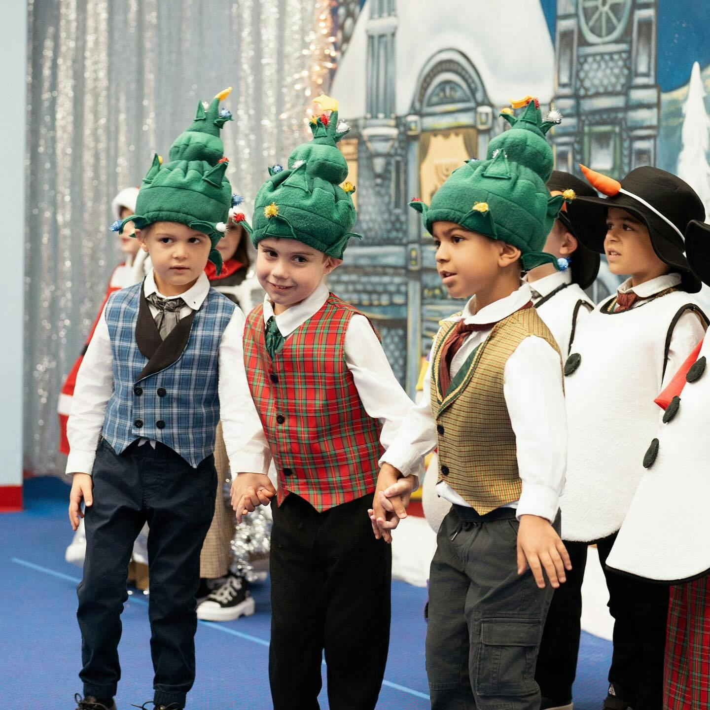 Children in holiday costumes holding hands