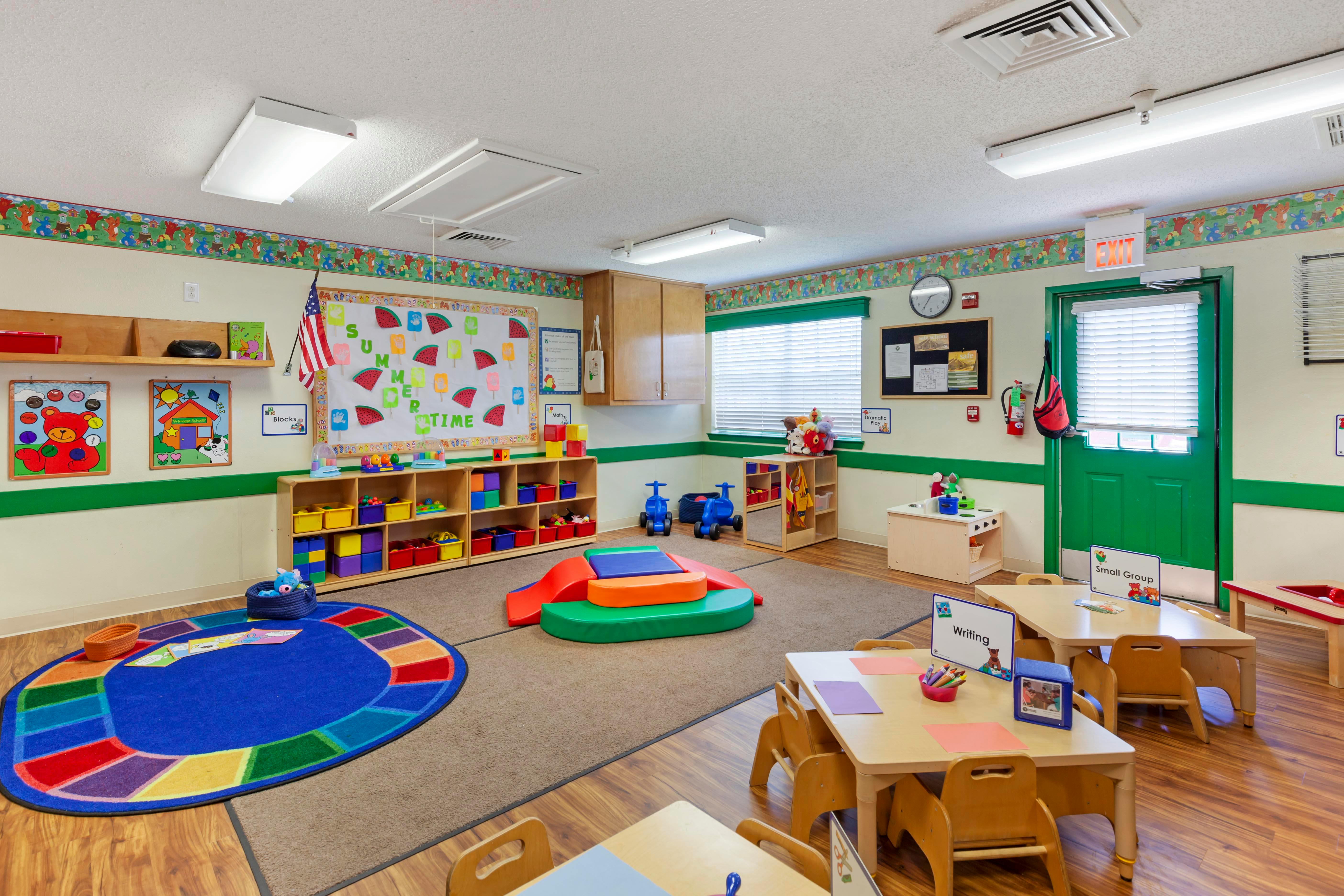 Colorful and organized classroom with children's furniture, toys, and learning materials