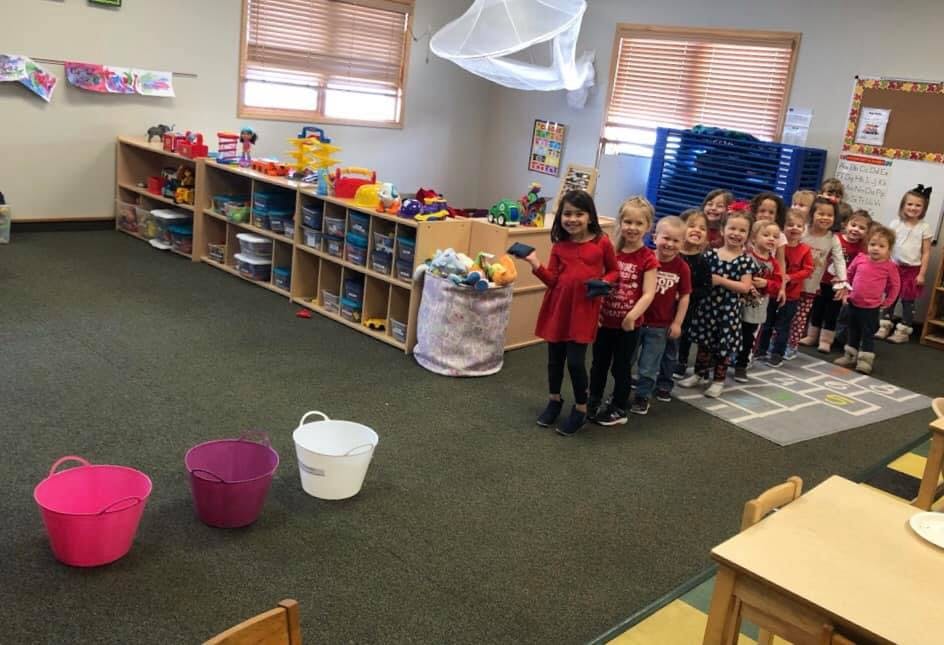 Children standing in a line in a classroom