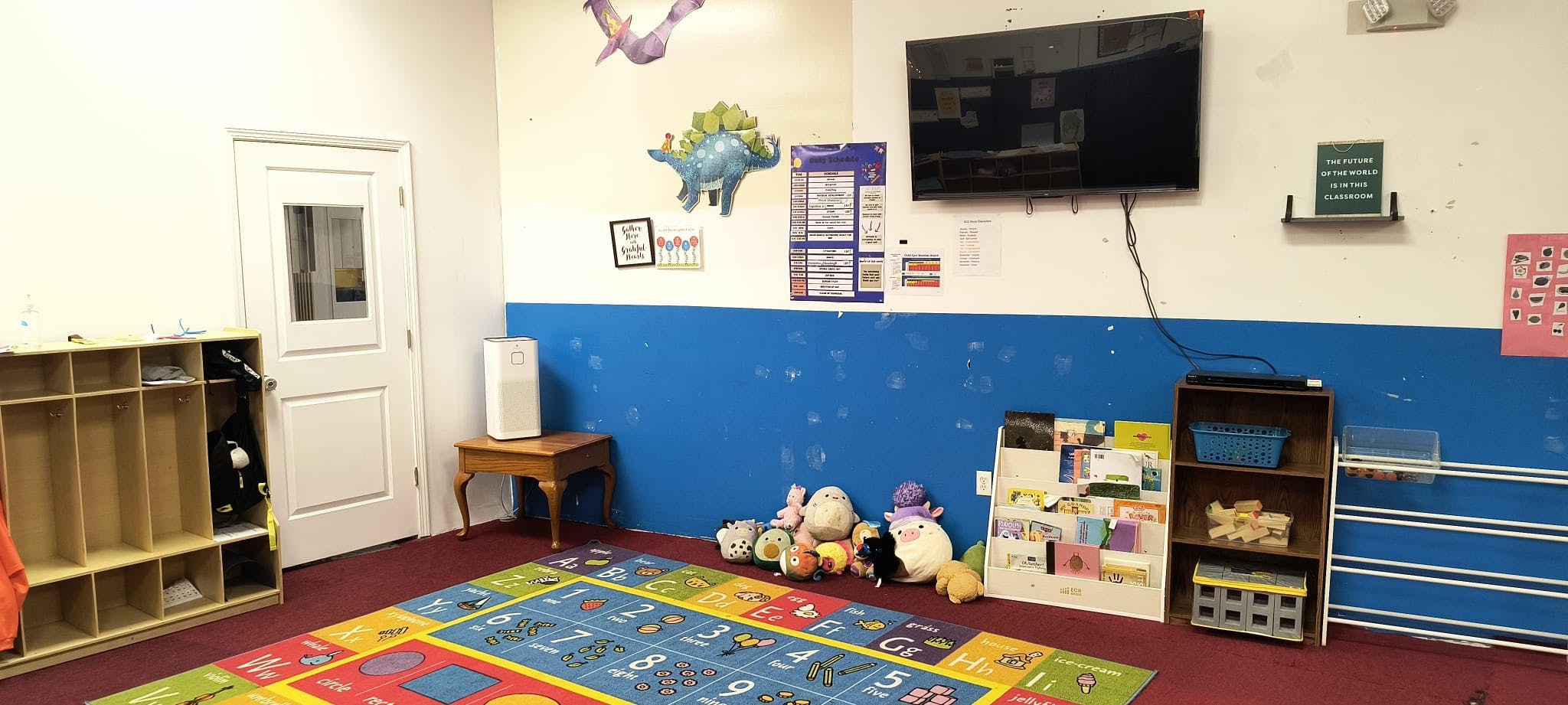 Playroom with colorful rug, toys, and wall decorations