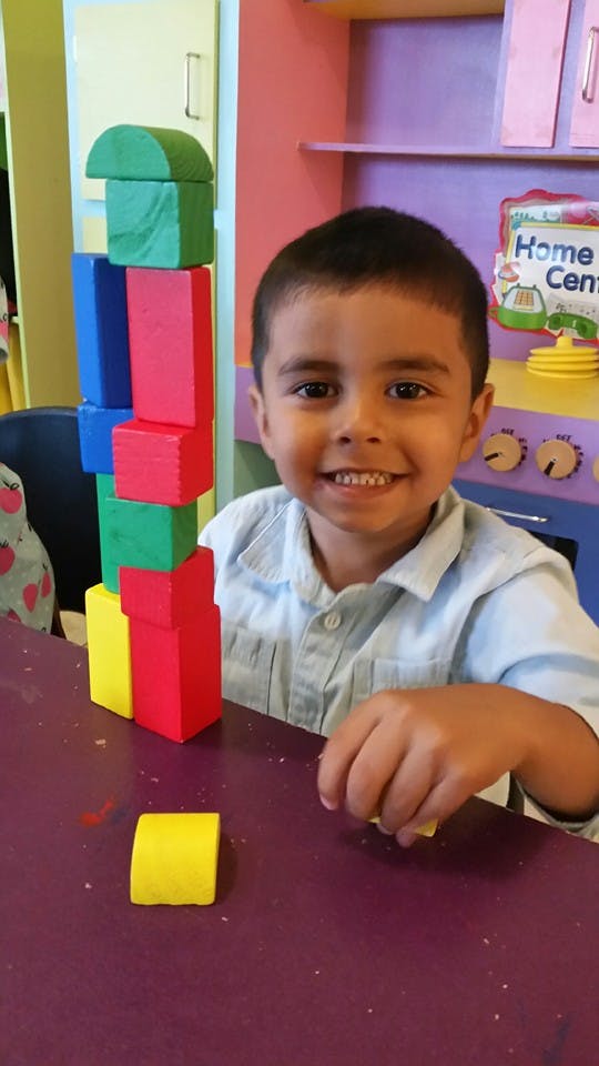 Child playing with colorful building blocks