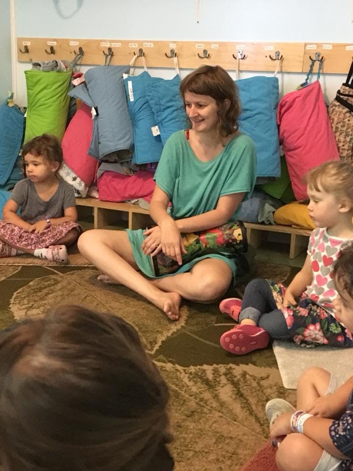 Person and children sitting on the floor