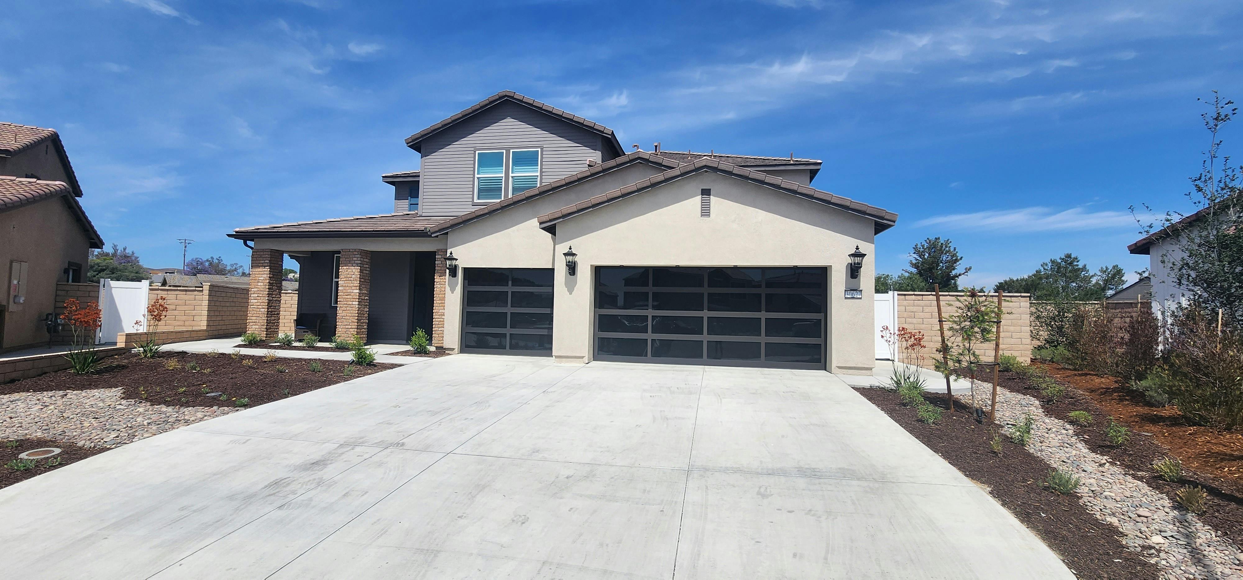 Two-story house with a two-car garage and a concrete driveway