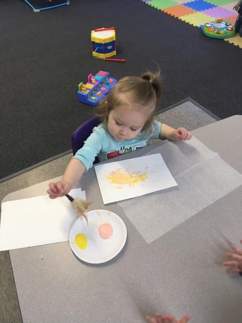 Child painting at a table