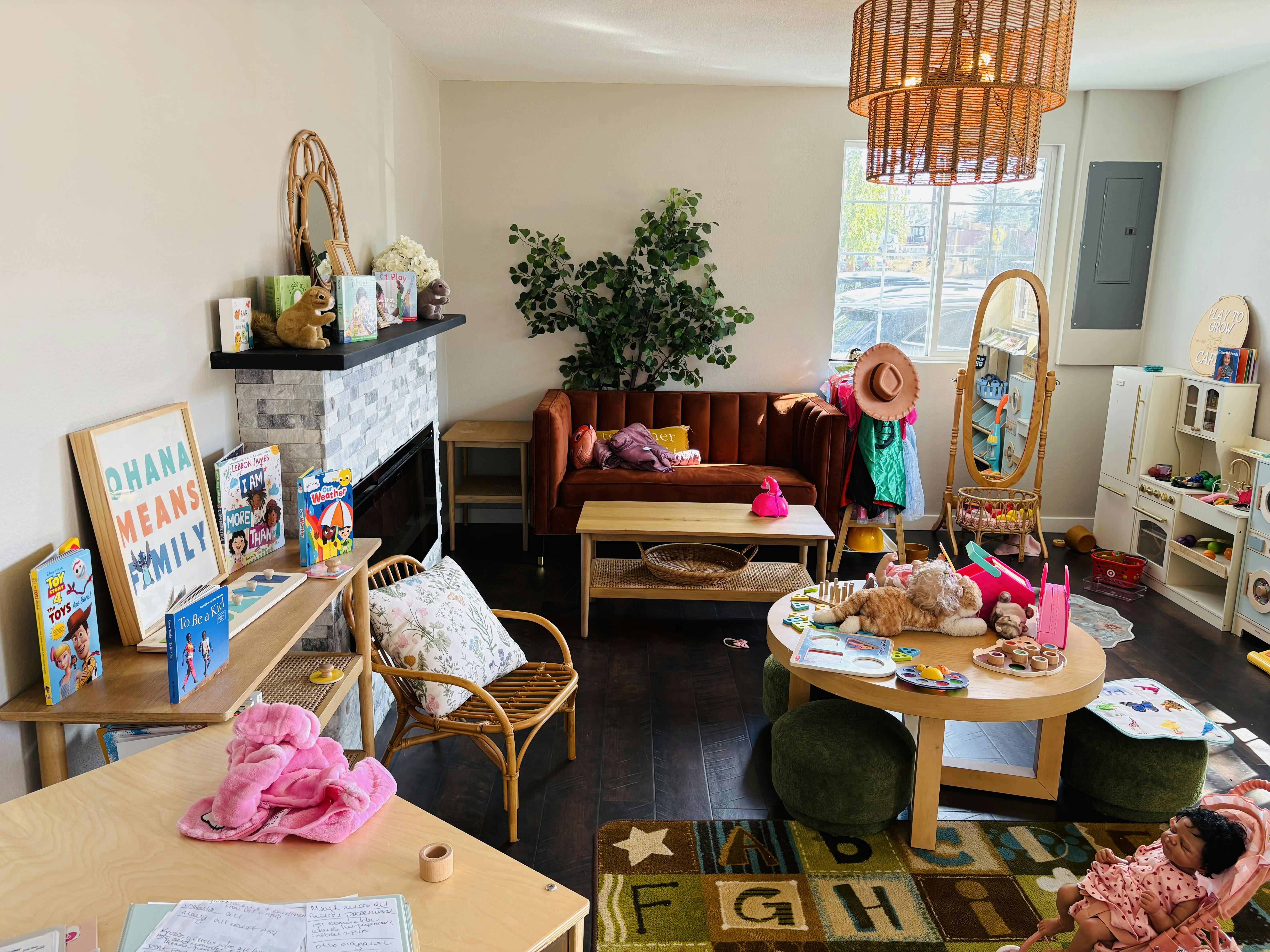 Child playroom with a seating area, low activity table, and toy storage