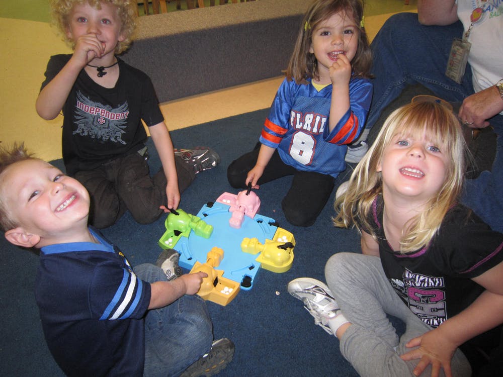 Children playing a board game on the floor
