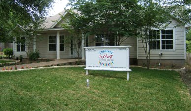 Building exterior with a sign that reads "Children's Summit"