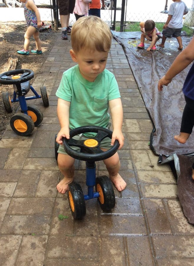 Child on a toy riding car