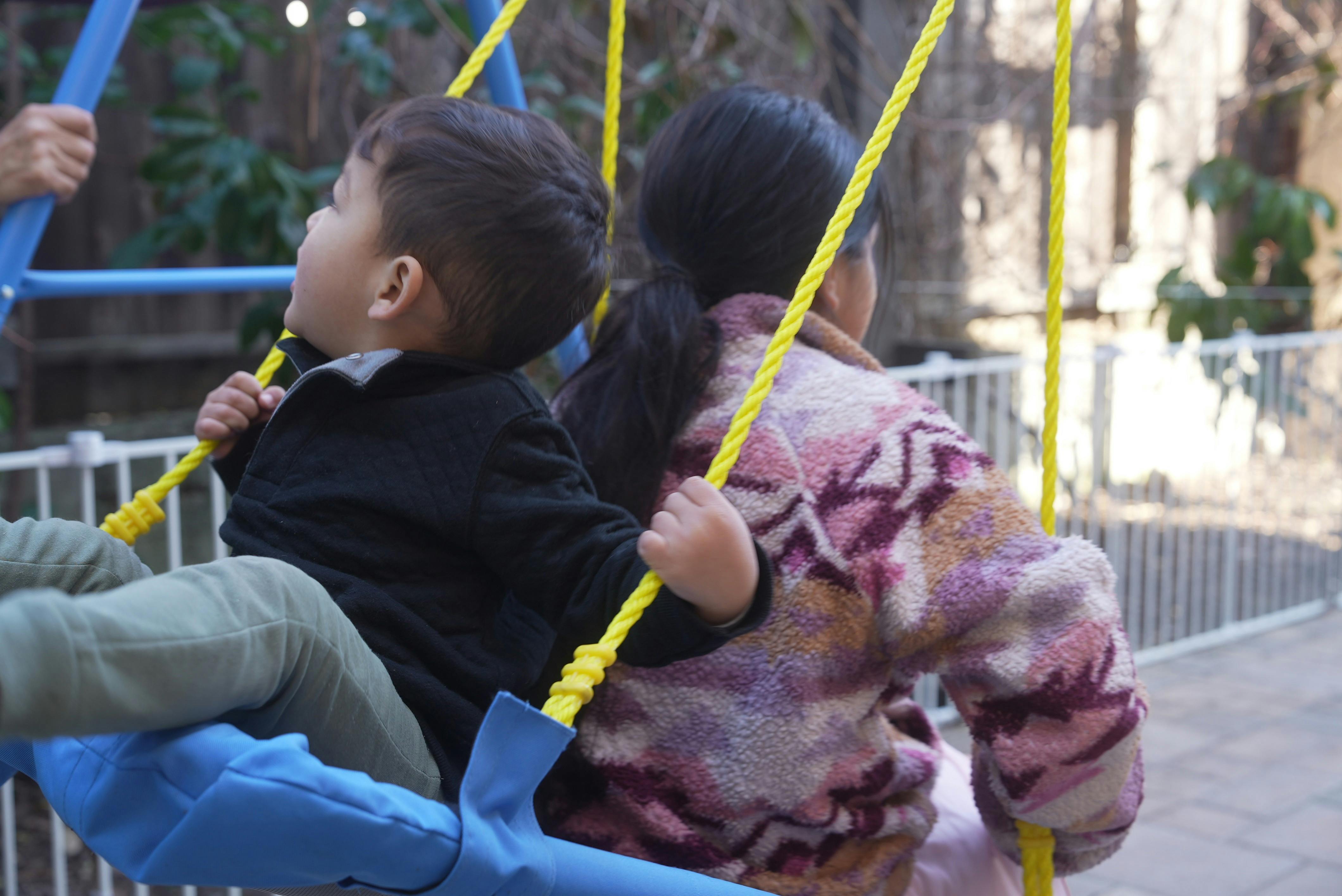 Two children on a swing set