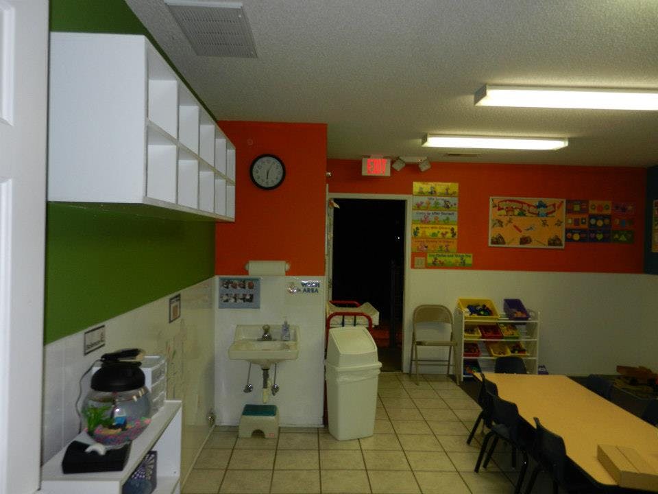 Classroom with sink, table, and chairs